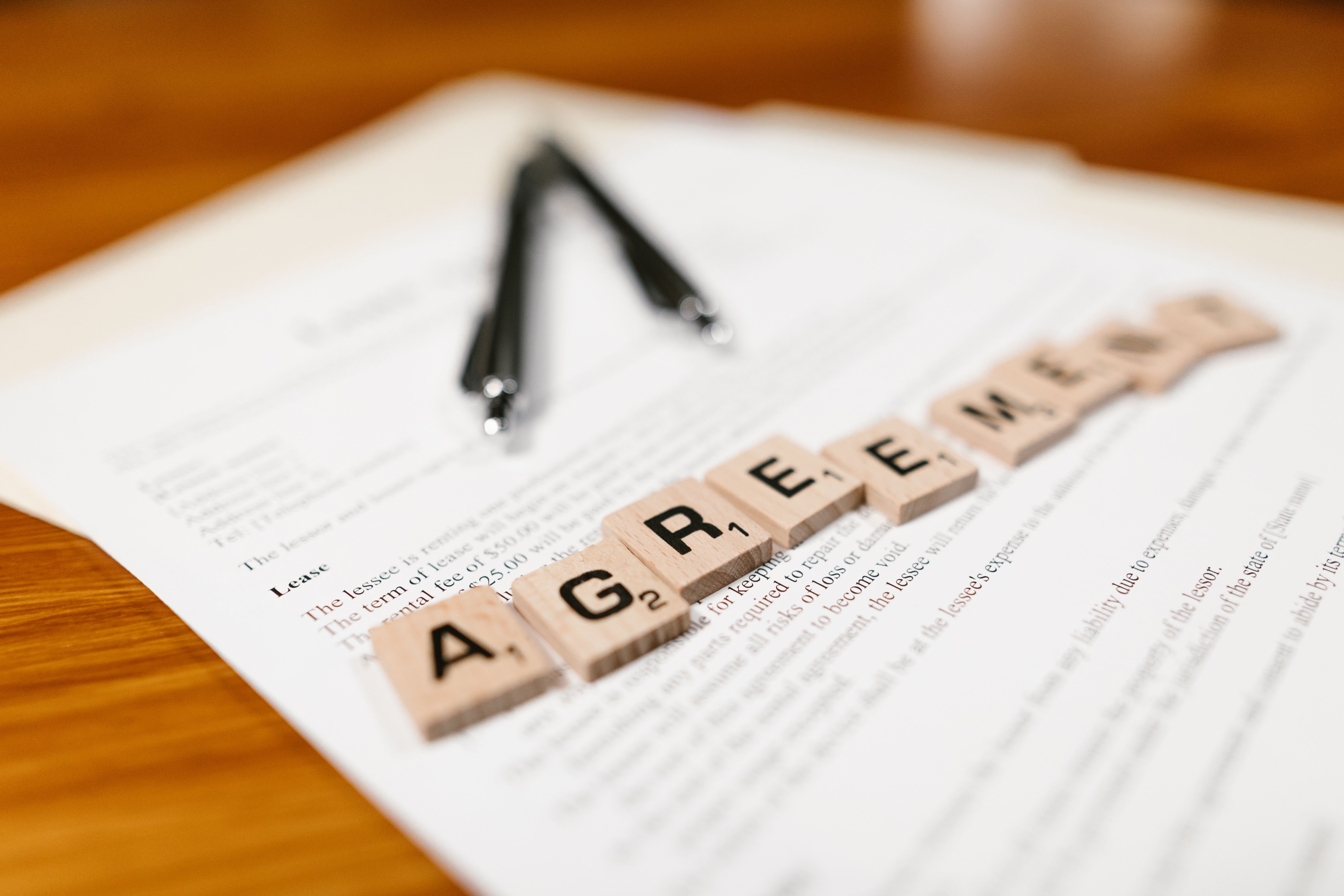 Tilt-shift%20photo%20of%20a%20rental%20agreement%20with%20game%20tiles%20that%20spell%20out%20AGREEMENT Tilt-shift photo of a rental agreement with game tiles that spell out AGREEMENT